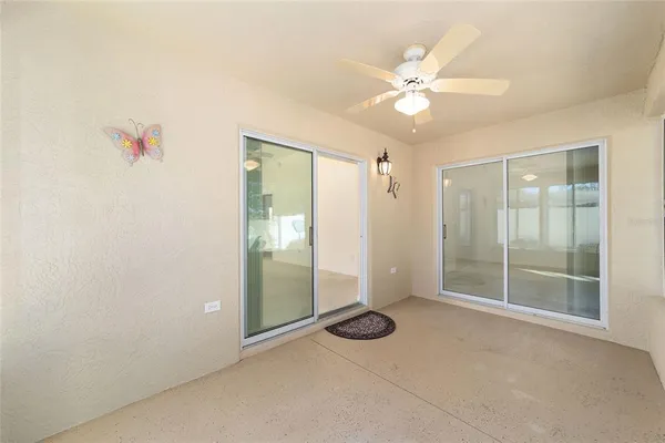 an empty room with a mirror and fan