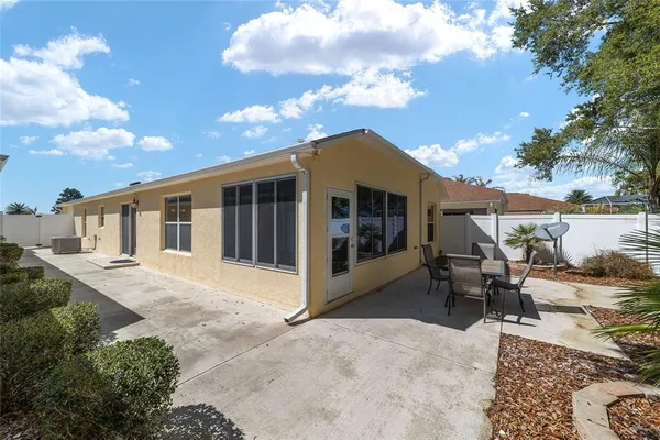 a view of a house with backyard and sitting area