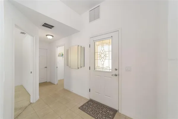 a view of a bathroom with white walls and tiles