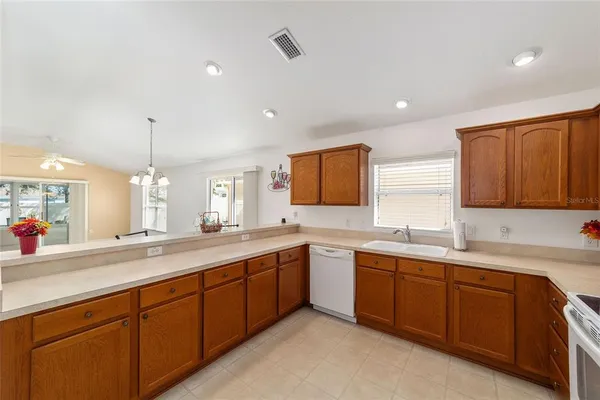 a kitchen with sink stove and cabinets