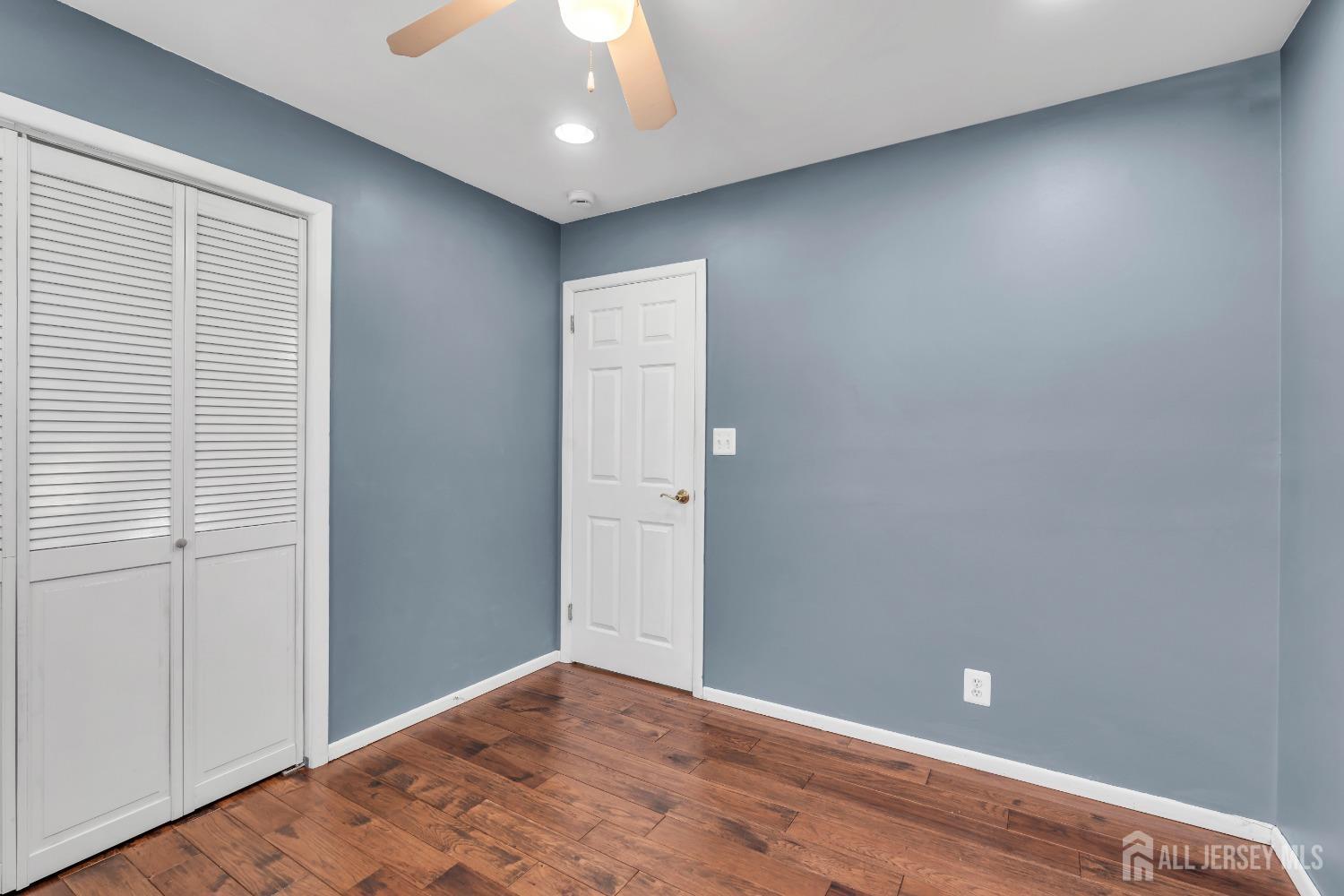 27 Brookside Road Edison, NJ 08817 - Photo 12 of 35 an empty room with wooden floor and windows