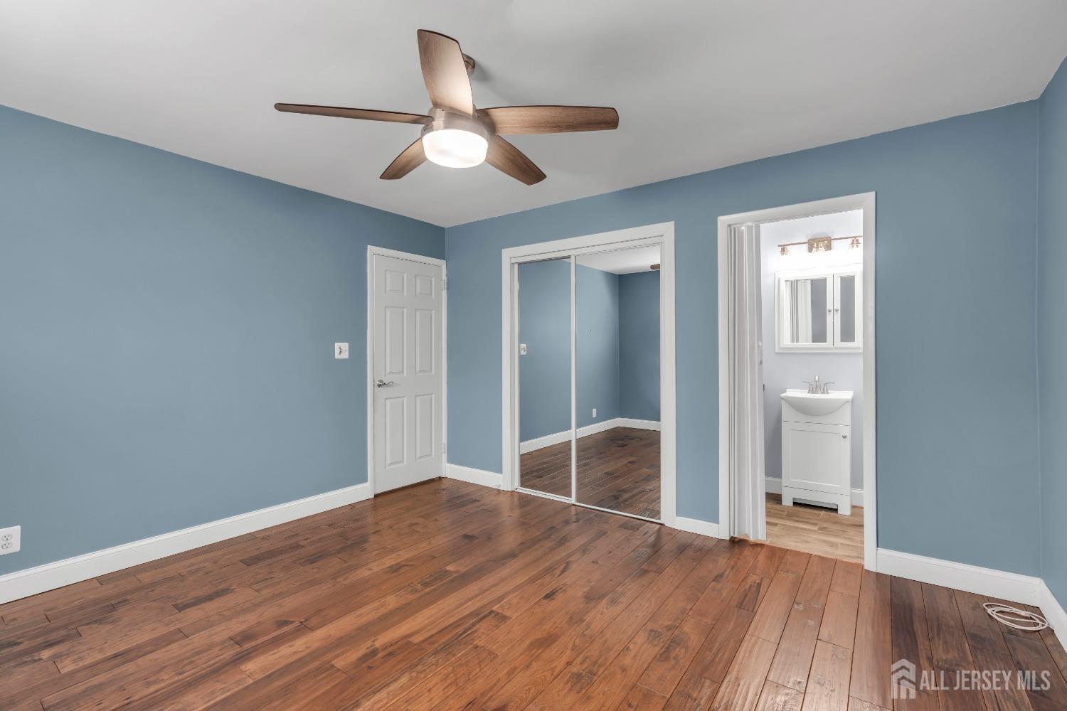 27 Brookside Road Edison, NJ 08817 - Photo 16 of 35 a view of a livingroom with wooden floor and a ceiling fan