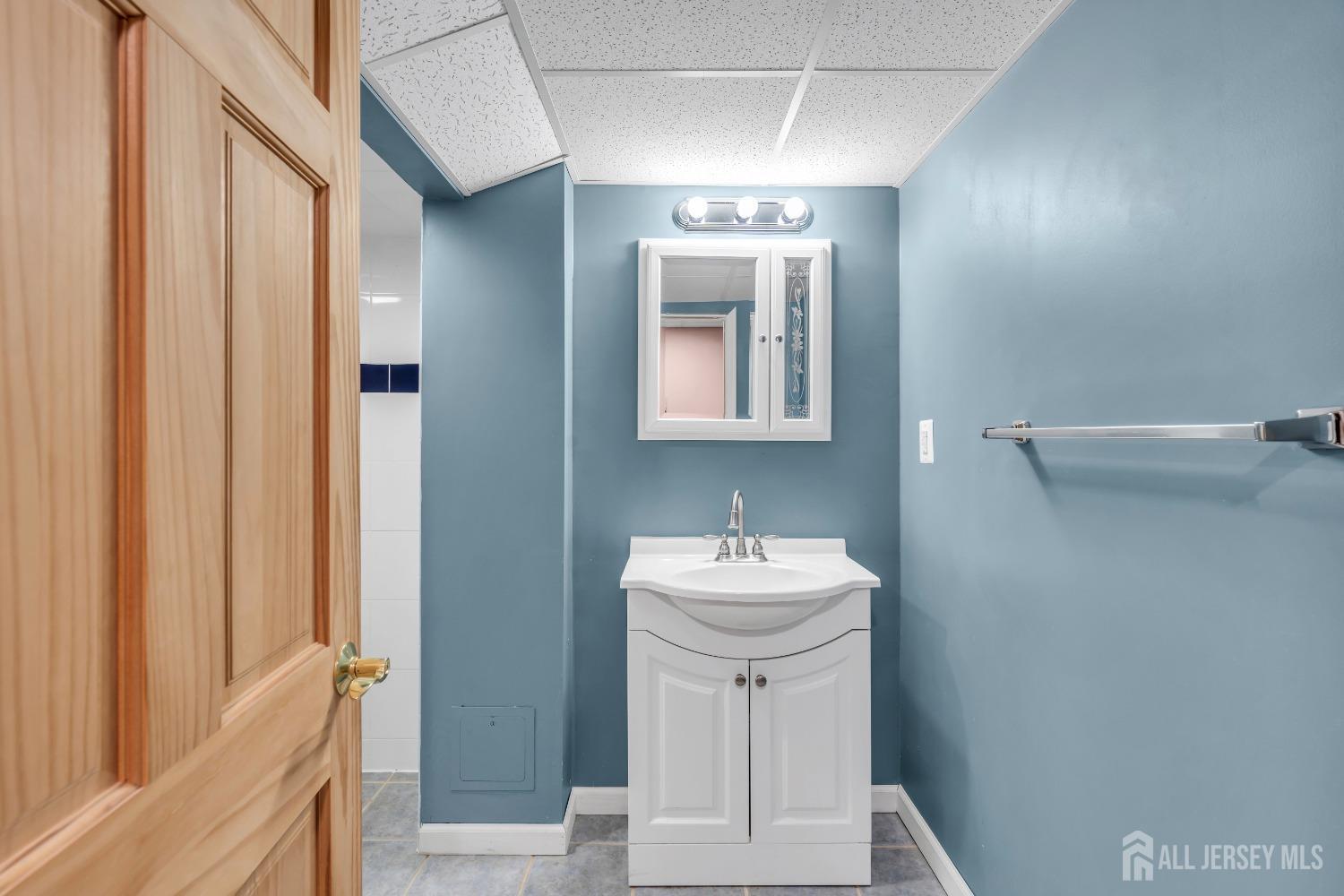 27 Brookside Road Edison, NJ 08817 - Photo 18 of 35 a bathroom with a sink and a mirror