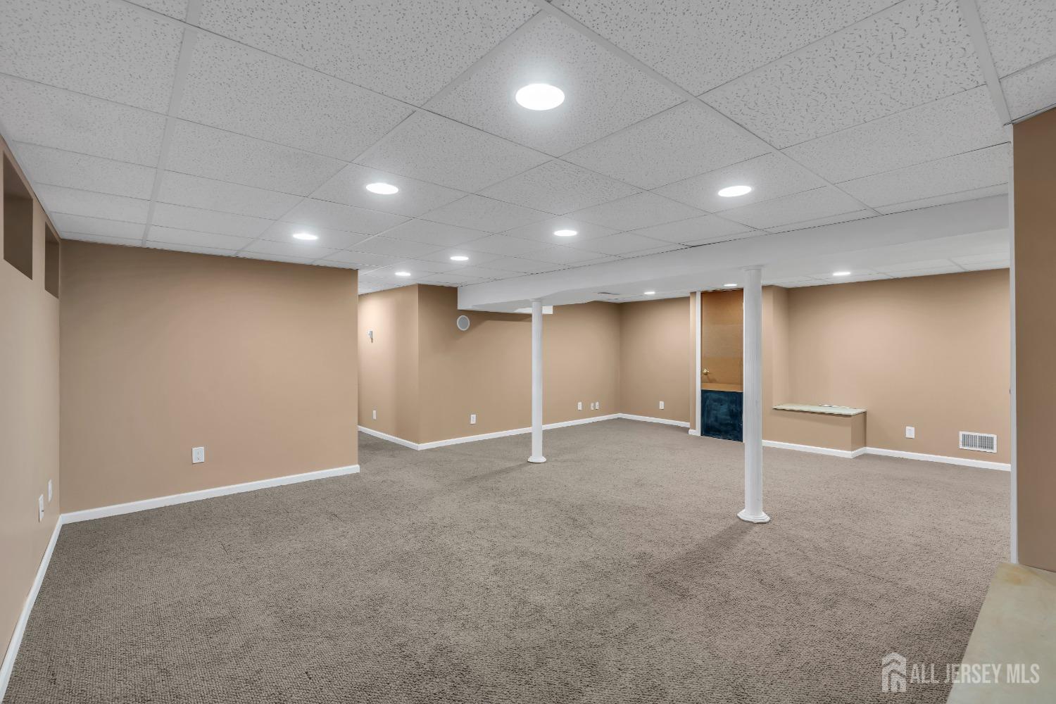 27 Brookside Road Edison, NJ 08817 - Photo 20 of 35 an empty room with windows and refrigerator