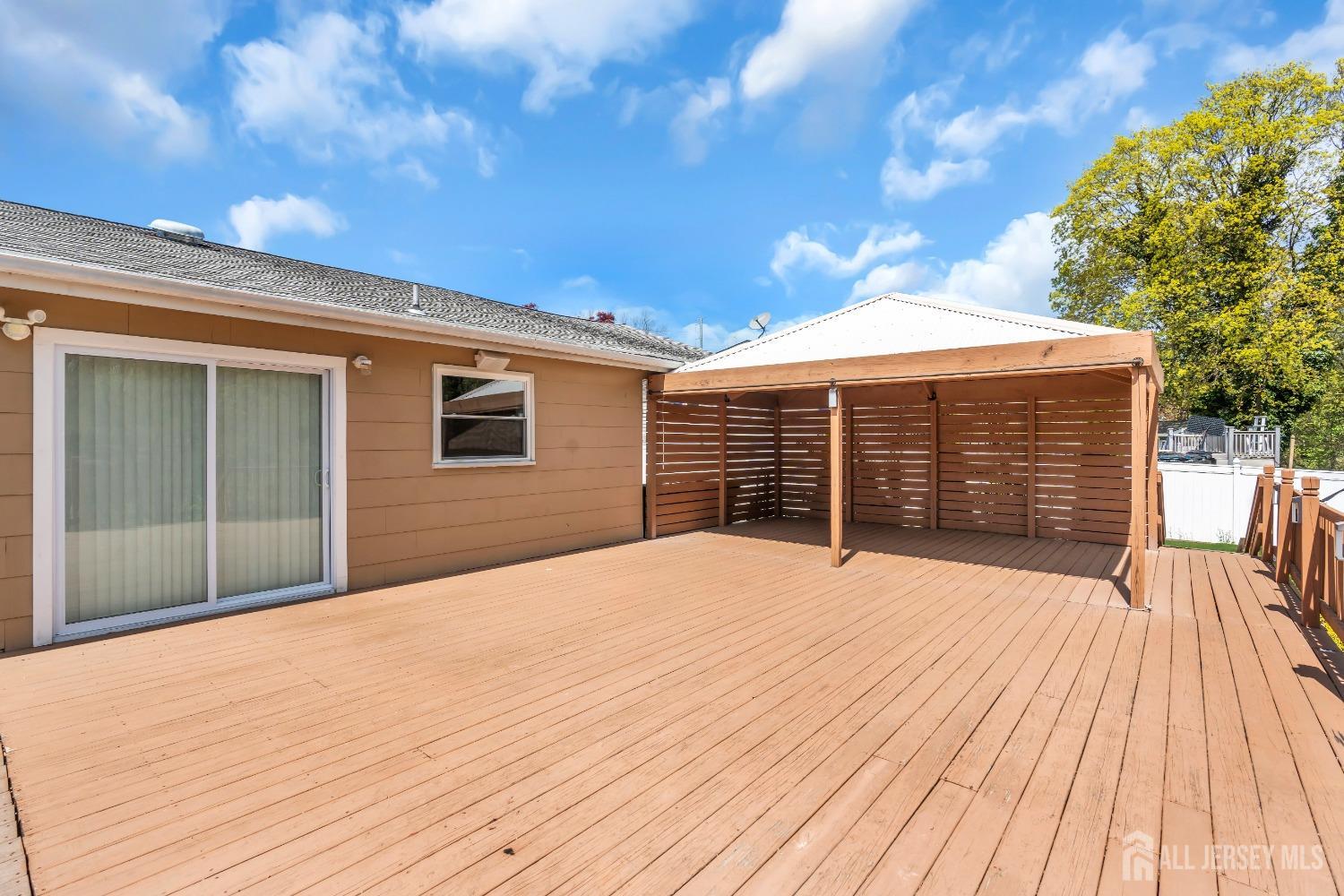 27 Brookside Road Edison, NJ 08817 - Photo 24 of 35 a view of an house with backyard and deck
