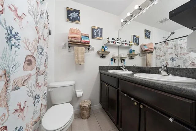 a sign that is sitting in front of a tree