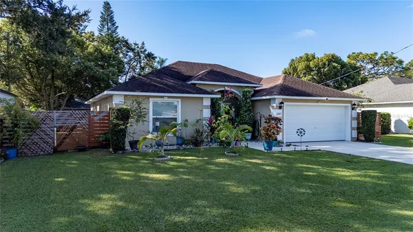a view of a house with a yard and sitting area