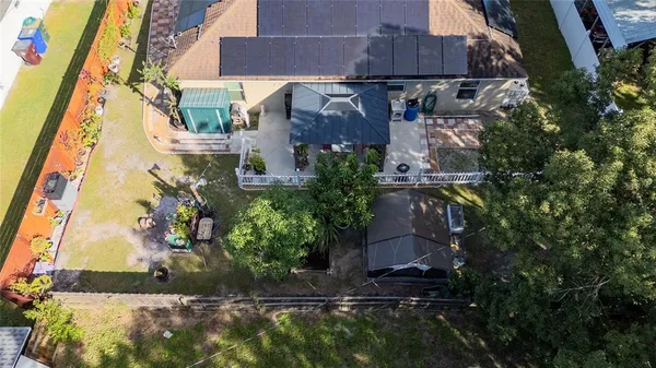 a view of a patio with table and chairs under an umbrella