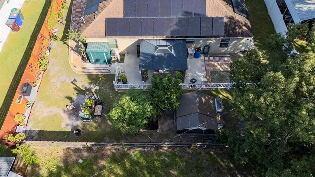 a view of a patio with table and chairs under an umbrella
