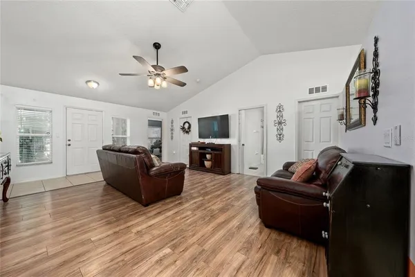a dining room with furniture a chandelier and window