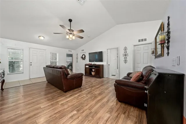 a dining room with furniture a chandelier and window