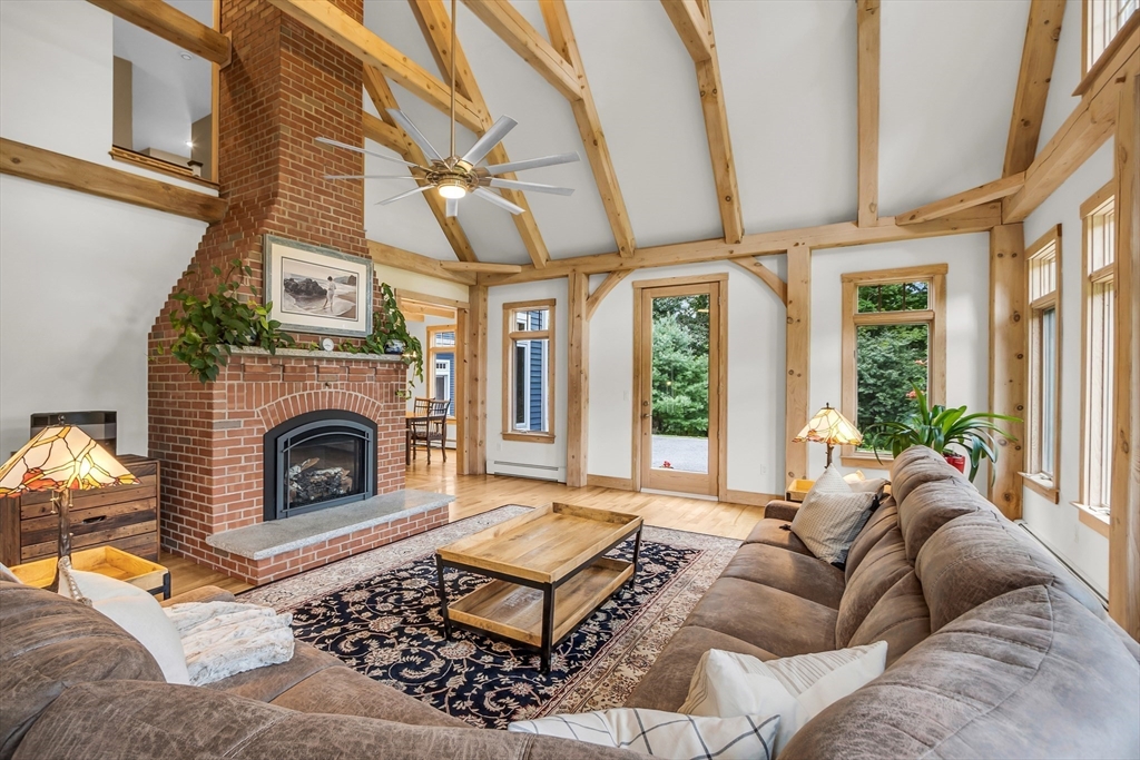 17 Randall Road Bolton, MA 01740 - Photo 4 of 39 a living room with furniture a flat screen tv and a fireplace