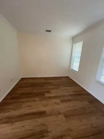 a view of room with window and hardwood floor