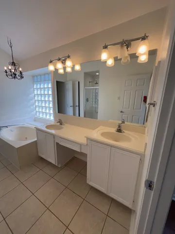 a bathroom with a bathtub sink and mirror