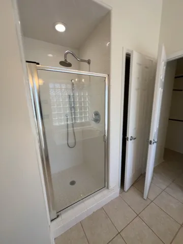 a bathroom with a glass shower door