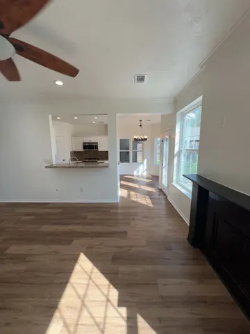 a view of large kitchen with wooden floor and electronic appliances