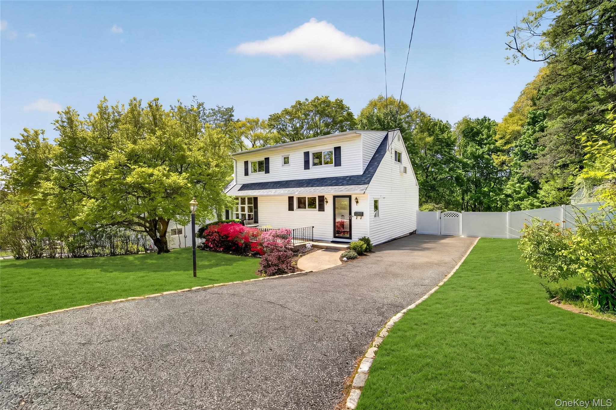 a view of a house with backyard and a tree