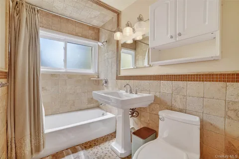 a bathroom with a sink a toilet and bathtub