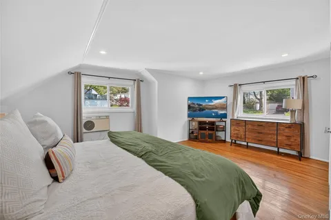 a bedroom with furniture and a wooden floor