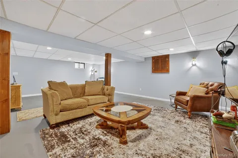 a living room with furniture a rug and a table