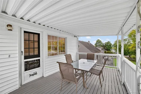 a view of balcony with furniture and wooden floor