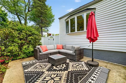 a house view with a sitting space and garden