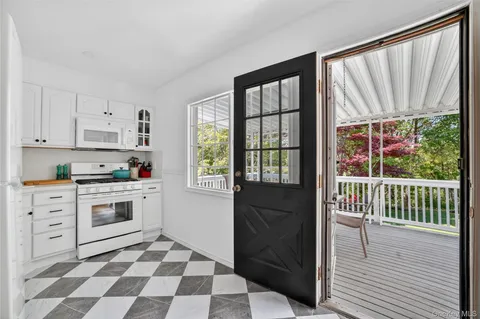 a kitchen with a stove a sink and a window