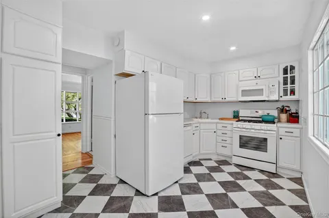 a kitchen with a stove a refrigerator and a sink