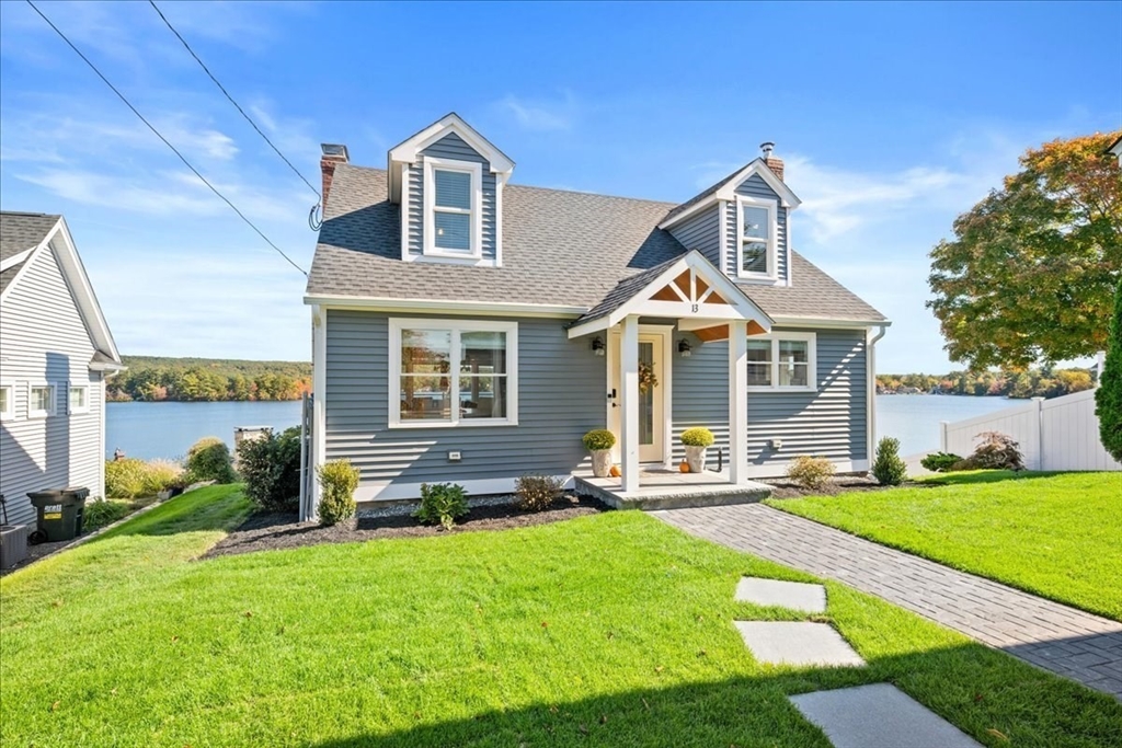 a front view of a house with a yard and porch