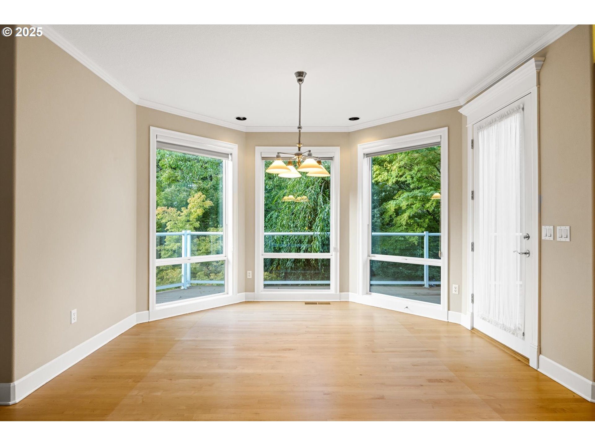 14014 Northwest 44th Court Vancouver, WA 98685 - Photo 12 of 47 a view of an empty room with wooden floor and windows