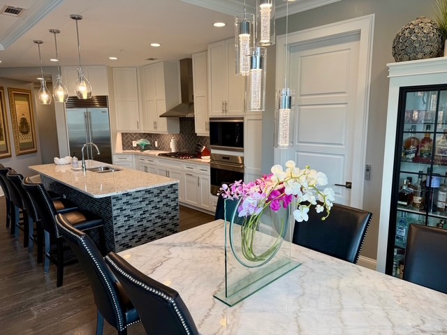 20 Rutledge Street, Unit 108 Nashville, TN 37210 - Photo 1 of 56 a kitchen with stainless steel appliances kitchen island granite countertop a refrigerator dining table and chairs
