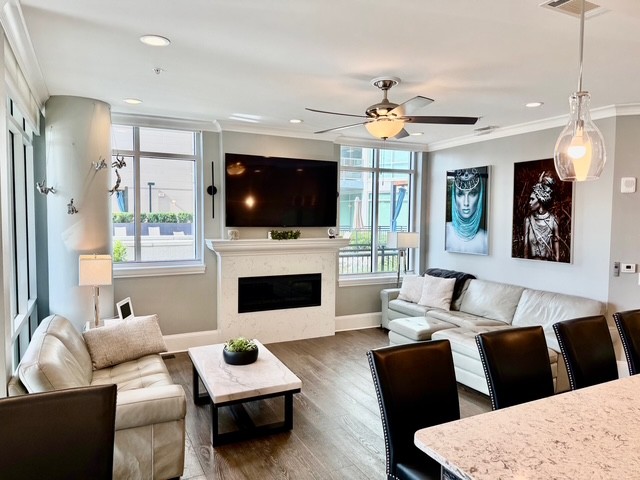 20 Rutledge Street, Unit 108 Nashville, TN 37210 - Photo 11 of 56 a living room with furniture a flat screen tv and a fireplace