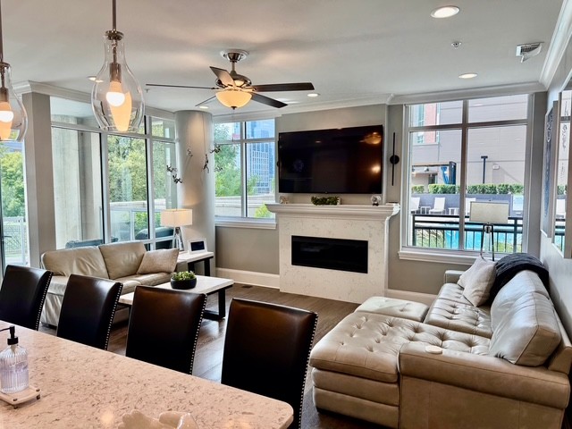 20 Rutledge Street, Unit 108 Nashville, TN 37210 - Photo 12 of 56 a living room with furniture a flat screen tv and a large window