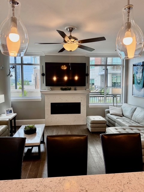 20 Rutledge Street, Unit 108 Nashville, TN 37210 - Photo 13 of 56 a living room with furniture a fireplace and a flat screen tv