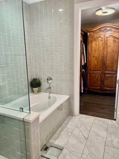 20 Rutledge Street, Unit 108 Nashville, TN 37210 - Photo 20 of 56 a bathroom with a tub a rug and a shower