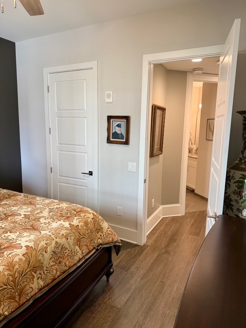 20 Rutledge Street, Unit 108 Nashville, TN 37210 - Photo 22 of 56 a bedroom with a bed and wooden floor