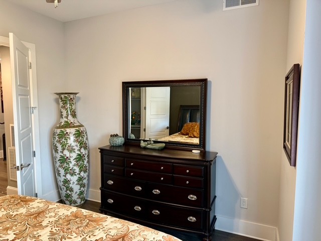 20 Rutledge Street, Unit 108 Nashville, TN 37210 - Photo 23 of 56 a bedroom with a bed and a dresser