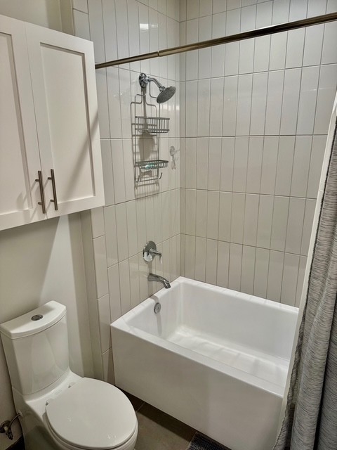 20 Rutledge Street, Unit 108 Nashville, TN 37210 - Photo 24 of 56 a white bath tub sitting next to a white toilet