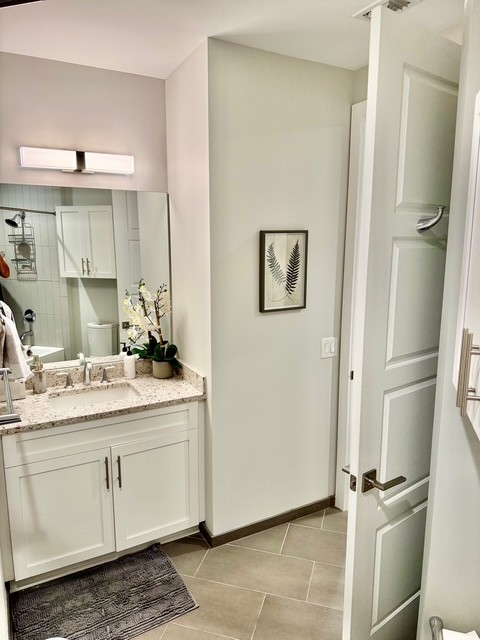 20 Rutledge Street, Unit 108 Nashville, TN 37210 - Photo 25 of 56 a bathroom with a double vanity sink and mirror