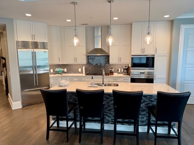 20 Rutledge Street, Unit 108 Nashville, TN 37210 - Photo 4 of 56 a dining room with stainless steel appliances kitchen island granite countertop a dining table chairs and a refrigerator