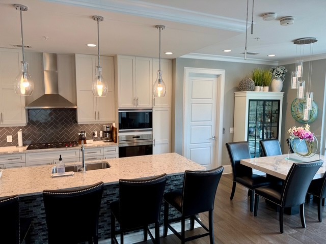 20 Rutledge Street, Unit 108 Nashville, TN 37210 - Photo 5 of 56 a kitchen with kitchen island a sink dining table and chairs