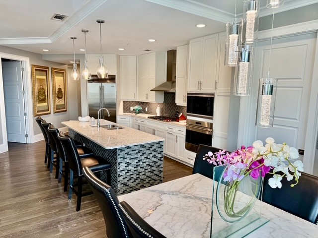 20 Rutledge Street, Unit 108 Nashville, TN 37210 - Photo 7 of 56 a outdoor dining room with stainless steel appliances kitchen island granite countertop a dining table chairs and a refrigerator