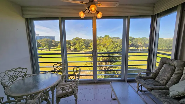 a living room with furniture and floor to ceiling windows