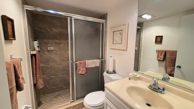 a bathroom with a sink toilet and shower