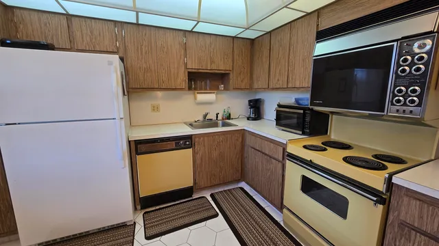 a kitchen with a refrigerator a stove a microwave and cabinets