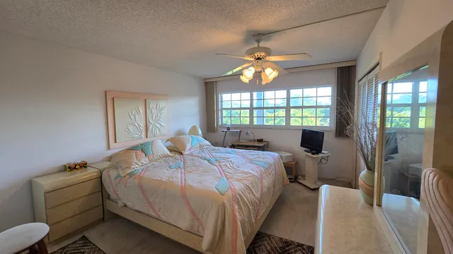 a bed room with a bed mirror and a window