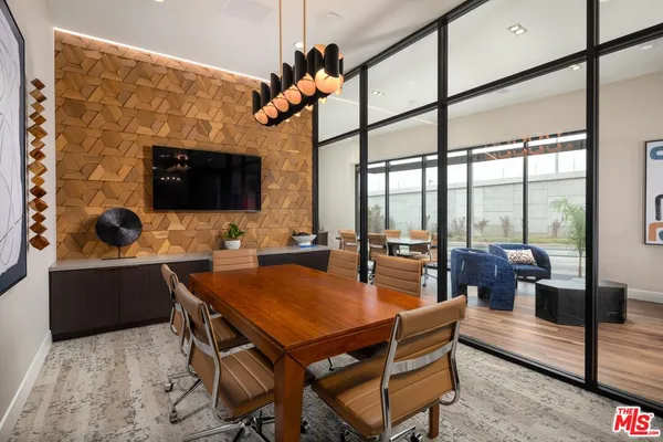 a dining room with wooden floor and furniture