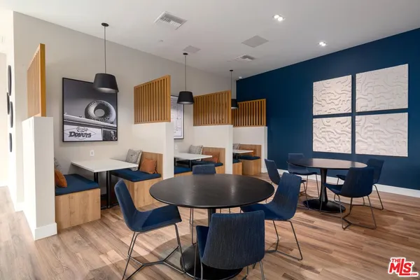 a living room with dining table and a wooden floor