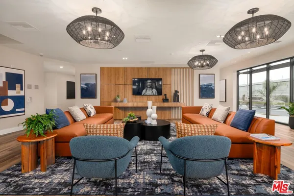 a living room with furniture a rug and a large window