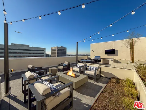 a view of outdoor kitchen with outdoor seating